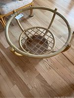 Top-down view of the rattan coffee table showing the circular rattan frame and lattice shelf base.