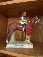 Front view showing Secretariat with jockey and inscription 'Secretariat Winner 99th Kentucky Derby - Sets New Track Record'