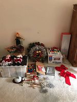 Full view of assorted Christmas decorations including wreath, ornaments, candy dish, bows, and boxes
