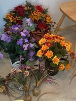 Overview of the six faux flower arrangements showing various colors and vase styles.