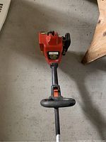 Top view of the orange gas engine unit of the Weedwacker trimmer showing the brand label and engine size 17/25cc.