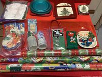 Overview of all Christmas party accessories including plates, cups, wrapping paper, towels, coasters, trivets, and clothespins.