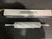 Photo of marble rolling pin with box labeled 'MARBLE ROLLING PIN WITH MARBLE BASE AND SOLID ALUMINUM HANDLE'.