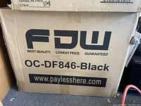 Cardboard shipping box labeled FDW OC-DF846-Black, indicating the chair brand and model new in the box.