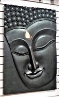 Front view of carved wooden Buddha head panel