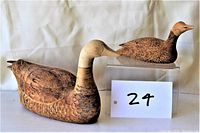 Photo showing two handcarved wooden ducks side by side with pyrography decoration, larger one signed D LeLiever.