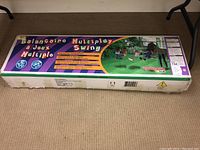 Boxed Sportspower Fit4Kids Multiplay Swing Set showing product name and branding.