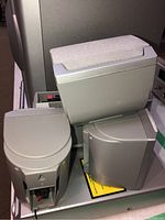 Compact grey speakers and subwoofer unit grouped together for identification.