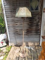 Full view of the 1930s tri-lite floor lamp showing metal base and the shape of the shade