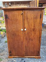 Closed front view showing double doors, porcelain knobs and overall finish