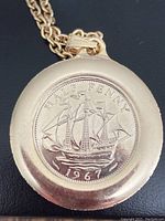 Front of the pendant showing the 1967 half penny coin with the sailing ship design and inscription 'HALF PENNY 1967'.