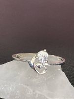 Front angle of small heart ring stamped 925 with round clear stone