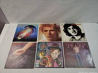 Front covers of six vinyl LP albums by David Bowie, Joe Cocker, Journey, Bruce Cockburn, John Cougar Mellencamp, and Culture Club arranged in two rows of three.