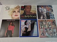 Front view of 6 vinyl record album covers including Madonna, Sade, Sheila E., Laura Branigan, Pat Benatar, and Bangles, displayed side by side.