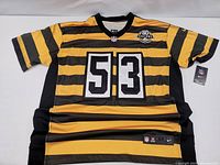 Front view of a yellow and black striped Pittsburgh Steelers replica jersey, showing number 53 with NFL and 80 Seasons patches.