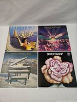 Four Supertramp vinyl records showing front covers of each album with distinct artwork.