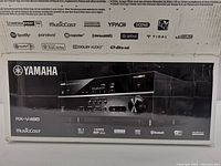 Front of box showing Yamaha RX-V485 MusicCast receiver branding and feature logos