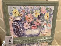 Frontal view of the oil painting showing the floral still life with blue vase, flowers in a bowl, framed and signed by artist.