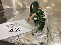 Close-up image of the handcrafted copper wire bracelet showing the large polished green oval stone and smaller green agate pieces arranged in a floral pattern.