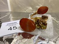 Photo shows handcrafted copper wire bracelet and ring with orange agate stones and detailed copper flower on bracelet.