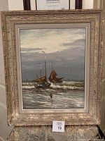 Framed oil painting by Helmut Reuter depicting several sailboats on a turbulent ocean under a cloudy sky with a lone figure on the shore. Framed dimensions visible.