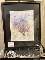 Full view of the framed watercolor painting showing abstract natural elements with branches and smooth pastel colors.