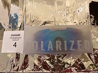 Photo of the closed rectangular packaging box with 'POLARIZED' visible through translucent cover.