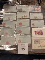 Top-down view of multiple US stamps affixed to typed documentation cards from US Stamp Department.