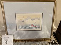 Framed woodblock print with title Fisher by Graham Scholes, showing overall framed artwork hanging on wall.