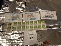 Several packets and loose stamps from Romania 1977 paintings, Rwanda 1970, Hong Kong, Romania 1983 in plastic and paper holders.