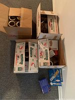 Partial boxes showing Bernardin mason jars in mixed quantities and other brand lid boxes.