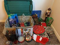 Overview of the Christmas lot items including wreaths, table linens, nutcracker, animated Santa, storage tub, and glass decorations.