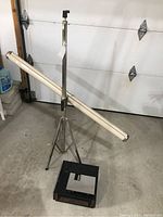 Knox Regent projection screen mounted on adjustable tripod stand with Sears slide projector on floor.