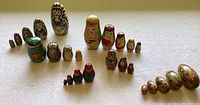 Six sets of nesting dolls arranged in rows, showing different sizes and designs.