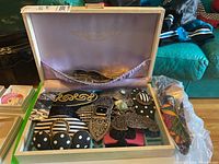 Open box showing assortment of hair clips in lined trays