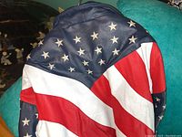 Back view of the leather jacket showing a large American flag pattern with stars and stripes in blue, red, and white.