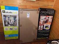 Overview of three boxed organizers including akada HOME closet organizer, IKEA HELMER drawers in brown box, Stack & Shelf boot/shoe organizer