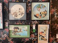 Four framed shadow boxes with Asian motif arranged on a dark floral wallpaper background showing the variety of designs and sizes.