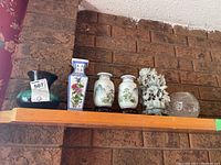 All six items displayed together on shelf against brick background