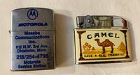 Photo showing both vintage advertising lighters side by side on a neutral background