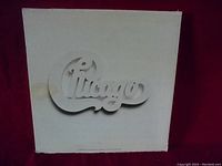 Box set cover with embossed Chicago logo in silver on white background.