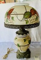 Full view of vintage table lamp with floral painted glass shade, metal trim, and ornate base