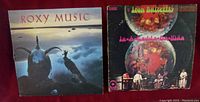 Both vinyl LP albums shown side by side, Iron Butterfly on the right and Roxy Music on the left.
