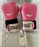 Pair of pink Everlast boxing gloves front view showing logos and wrist straps