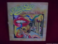 Front cover of Steely Dan vinyl album "Can't Buy a Thrill" featuring colorful and surreal artwork.