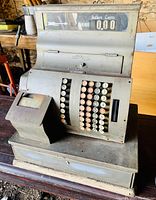 Front view photo of the vintage National cash register showing keys, display, and receipt printer section.