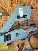 Side view of the Beaver 10 band saw showing the brand label, power switch, metal work surface, and attached cord.