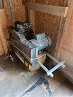 Full view of the blue and black Campbell Hausfeld compressor with wheels, showing the tank, motor, and handle for mobility.