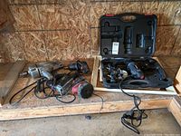 Photo showing all tools in lot including Black & Decker drill, auto polisher with wire brush, TMT jigsaw in case, Craftsman rotary cutting tool, and MorPower drill