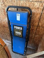 Shop creeper standing against plywood wall showing front view with logo visible.